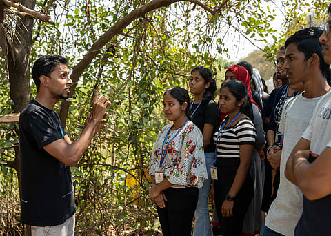 Sylvester (left) talks to a group of people